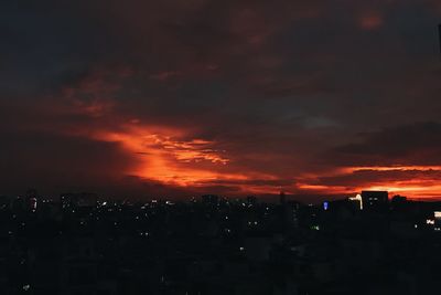 Silhouette buildings against sky during sunset