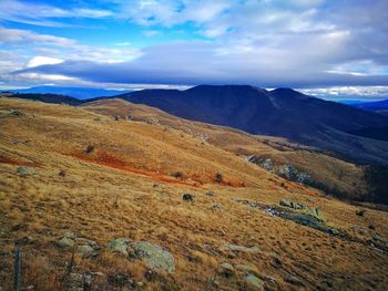 Scenic view of mountains against cloudy sky