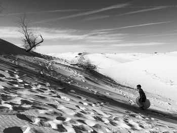 Boy climbing sandy hill at monahans sandhills state park