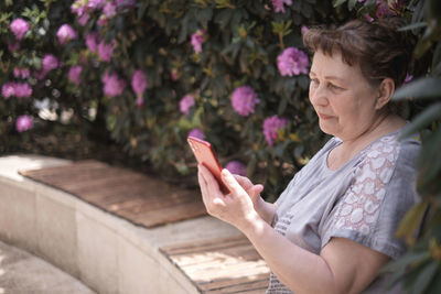 Mature woman using smart phone