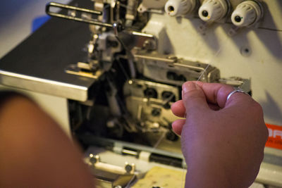 Cropped hands using sewing machine