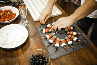 High angle view of man preparing food on cutting board