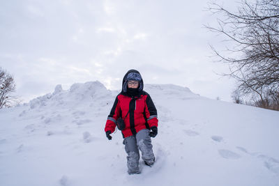 Kid on snow hill