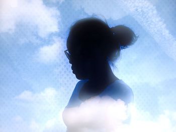 Low angle view of silhouette woman against sky