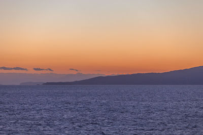 Scenic view of aegean sea against romantic sky at sunset