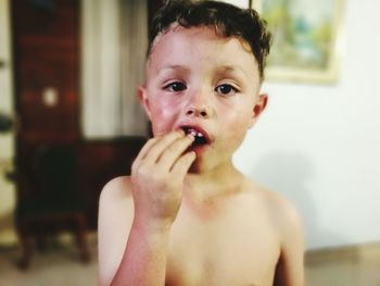 Close-up portrait of boy eating