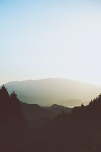 Scenic view of silhouette mountains against clear sky