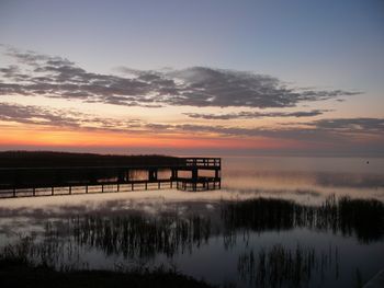 Scenic view of lake against orange sky