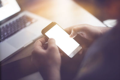 Midsection of man using mobile phone