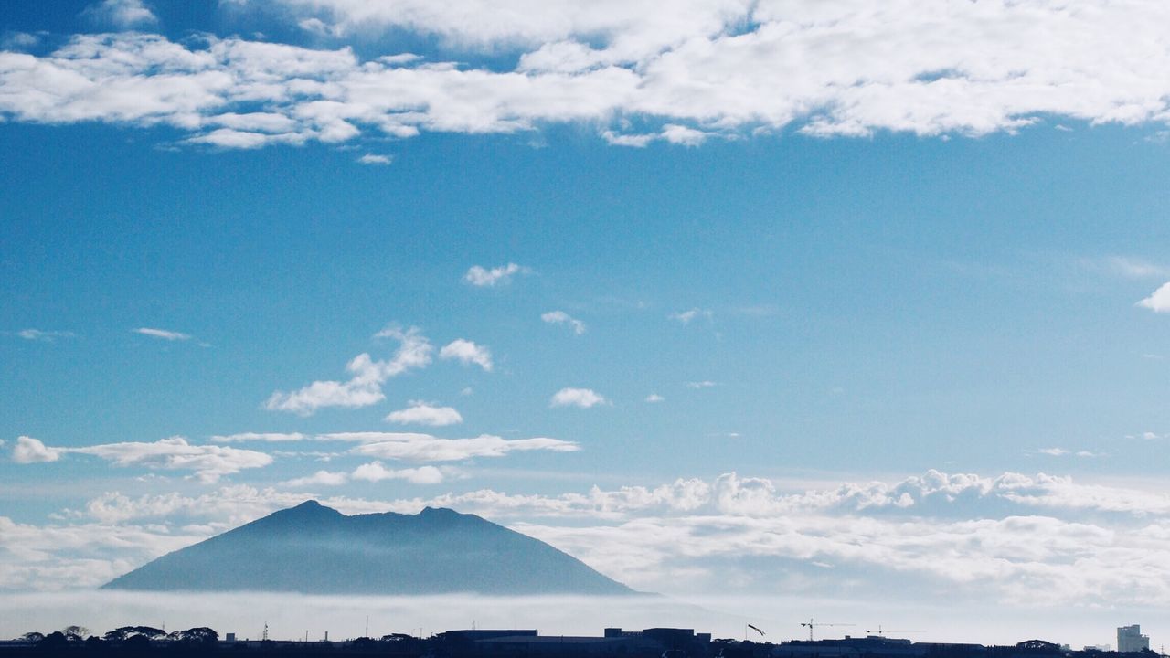 sky, cloud - sky, blue, building exterior, built structure, scenics, architecture, beauty in nature, cloud, mountain, tranquil scene, tranquility, nature, sunlight, cloudy, landscape, mountain range, outdoors, day, idyllic