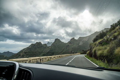 Scenic view of mountains seen through car windshield