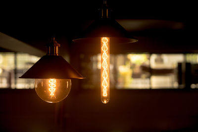 Close-up of illuminated light bulbs in darkroom