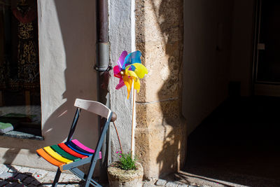 Multi colored umbrella against wall of house