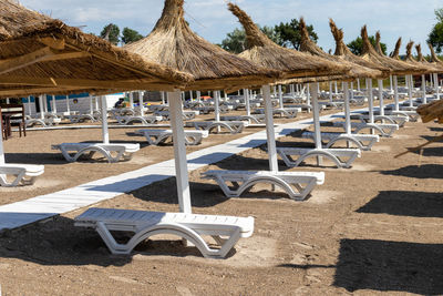 Empty chairs and tables at beach