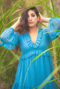 Beautiful woman standing against blue sky