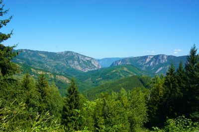 Scenic view of mountains against clear blue sky