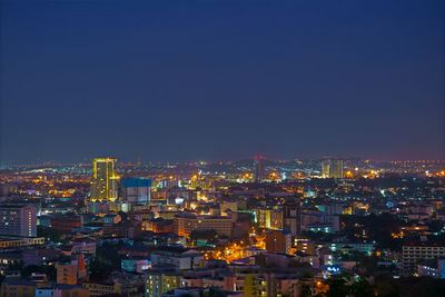 High angle view of illuminated city buildings against clear sky