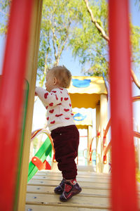 Boy playing on slide at playground