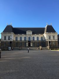 Facade of historic building against clear blue sky