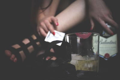 Midsection of woman holding drink