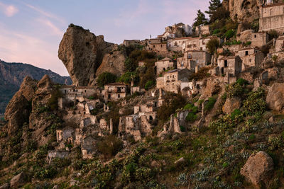 Ancient buildings of pentedattilo against sky