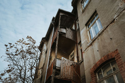 Low angle view of old abandoned building against sky