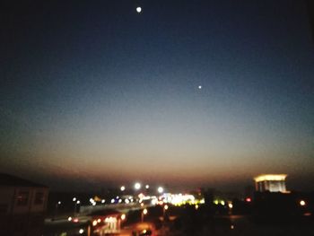 Illuminated city against sky at night