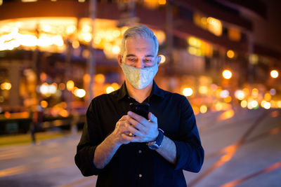 Man using mobile phone at night