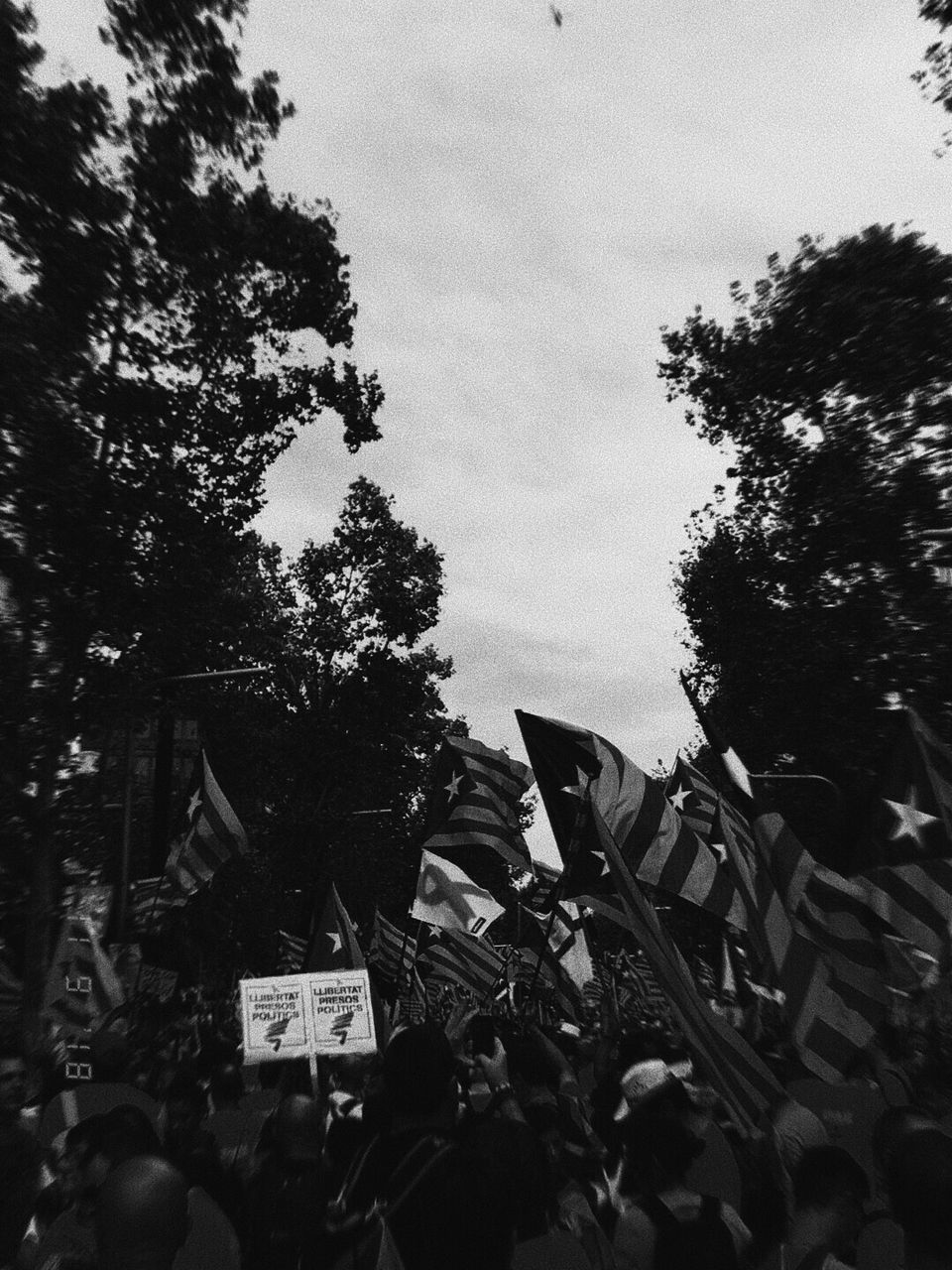 PEOPLE ON STREET AGAINST SKY