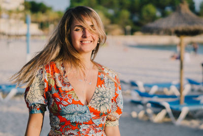 Portrait of smiling young woman at beach