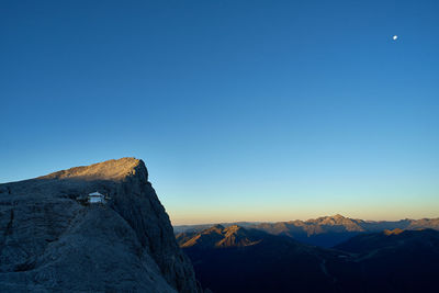 Scenic view of mountains against clear blue sky