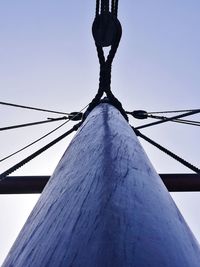 Low section of bare tree against clear blue sky