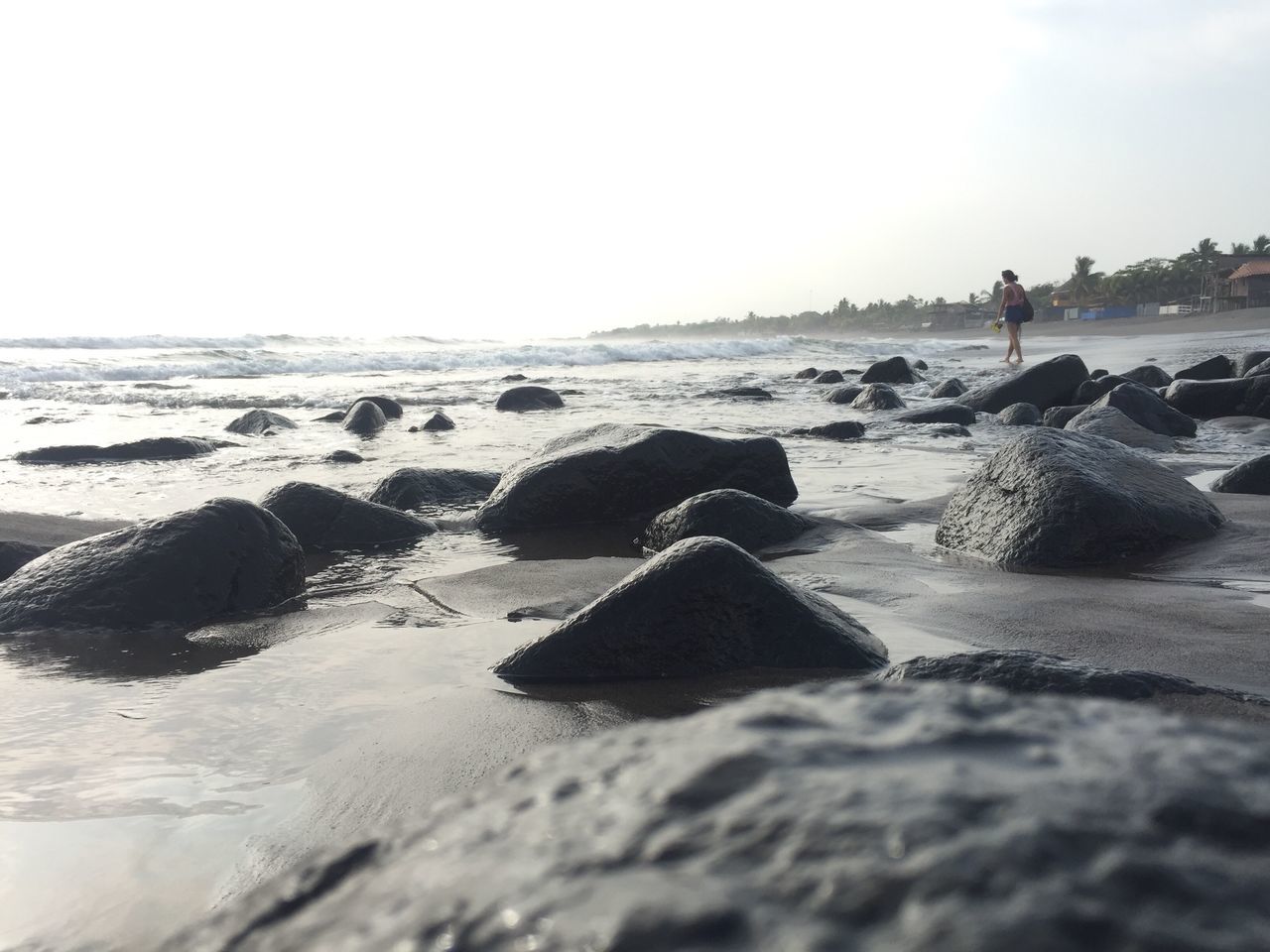 sea, beach, water, rock - object, horizon over water, nature, tranquil scene, scenics, beauty in nature, wave, day, outdoors, tranquility, sky, one person, pebble beach, people