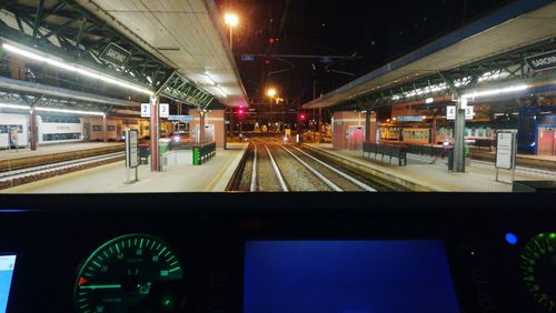 Train at illuminated railroad station at night