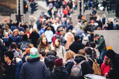 People walking on city street at night