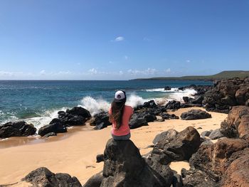 Full length of rocks on beach against clear sky