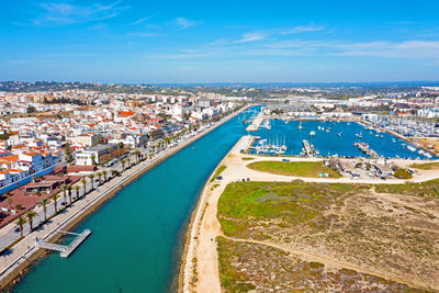 High angle view of buildings by sea against sky