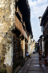 Narrow street amidst buildings in city