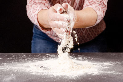 Cropped hand of person pouring water