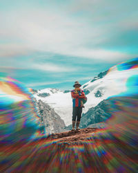 Man standing on mountain against sky