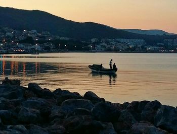 Boat in sea at sunset