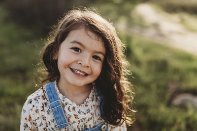 Portrait of young woman standing outdoors