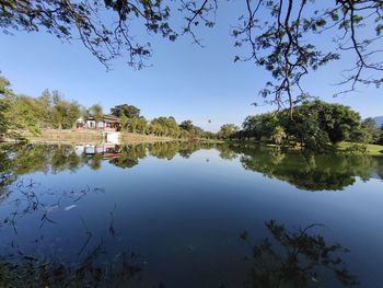 Scenic view of lake by building against sky