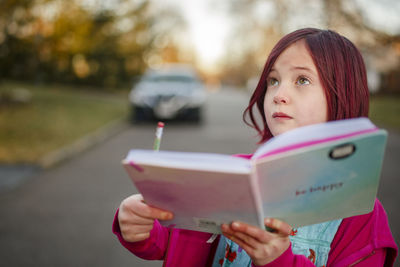 Portrait of woman holding book