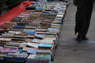 Low section of person standing by books at market