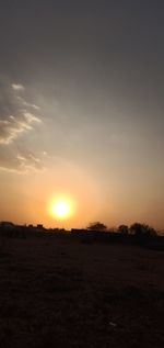 Scenic view of silhouette field against sky during sunset