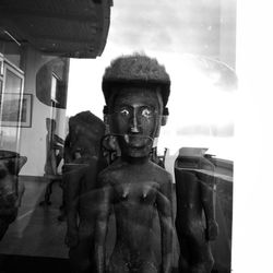 Close-up of statue against window