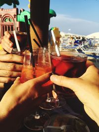 Close-up of cropped hand holding beer glass