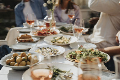 Food and salad with drinks arranged on table during dinner party at cafe