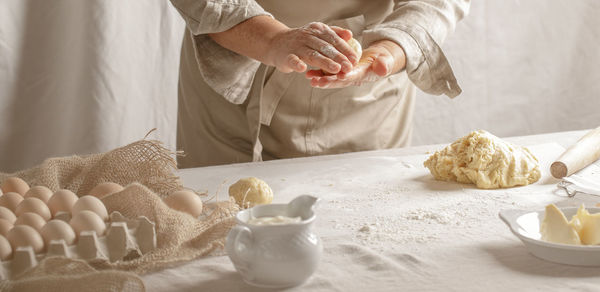 Midsection of man preparing food on table